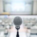 Microphone over blurred business forum