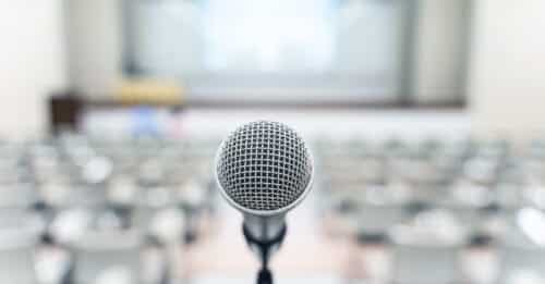 Microphone over blurred business forum