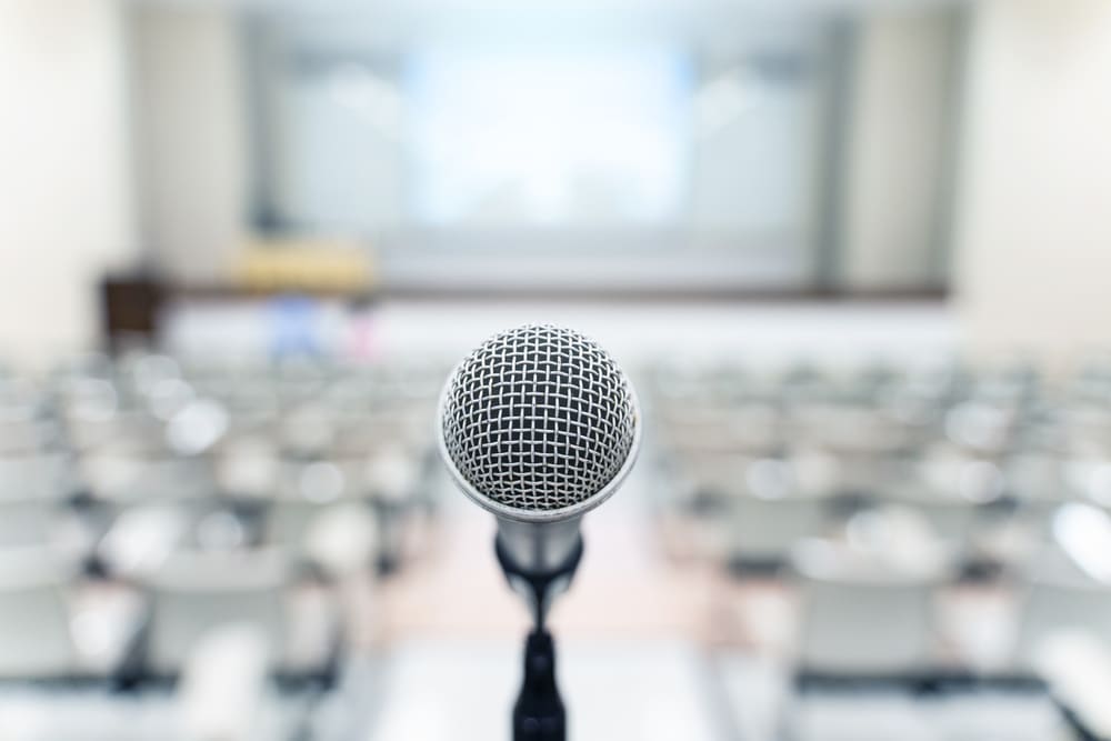 Microphone over blurred business forum